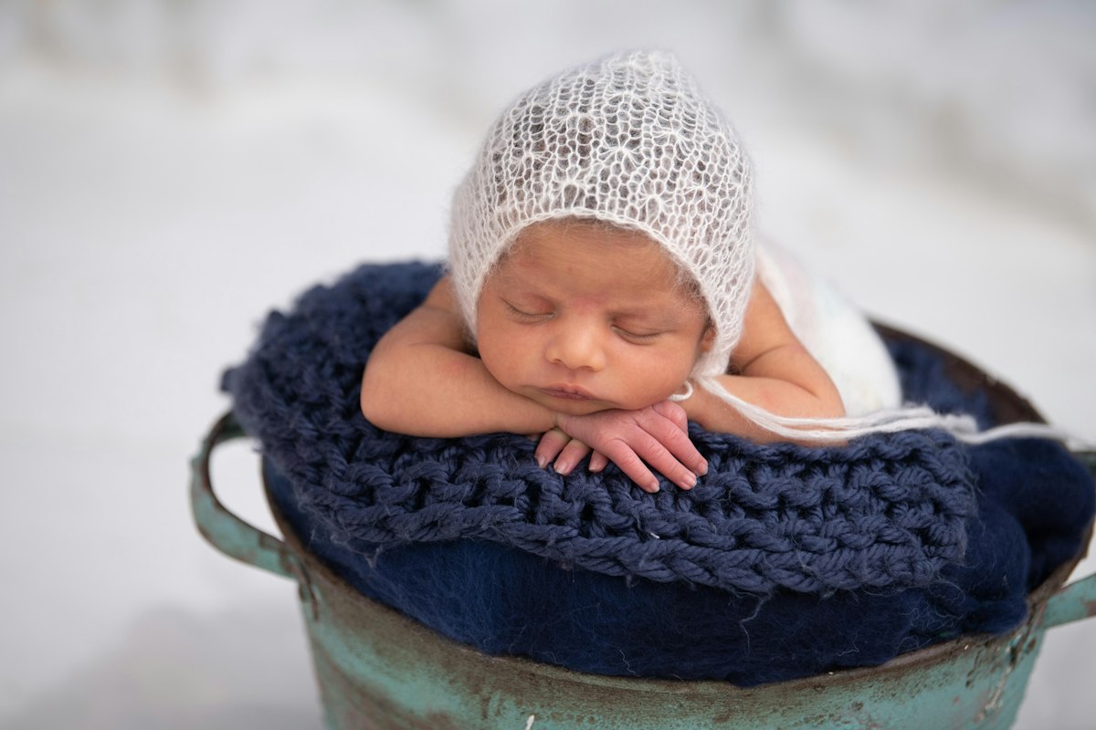 Baby sleeping in a carrier outdoors
