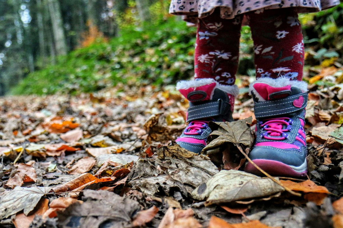 Child's hiking boots on a dirt trail